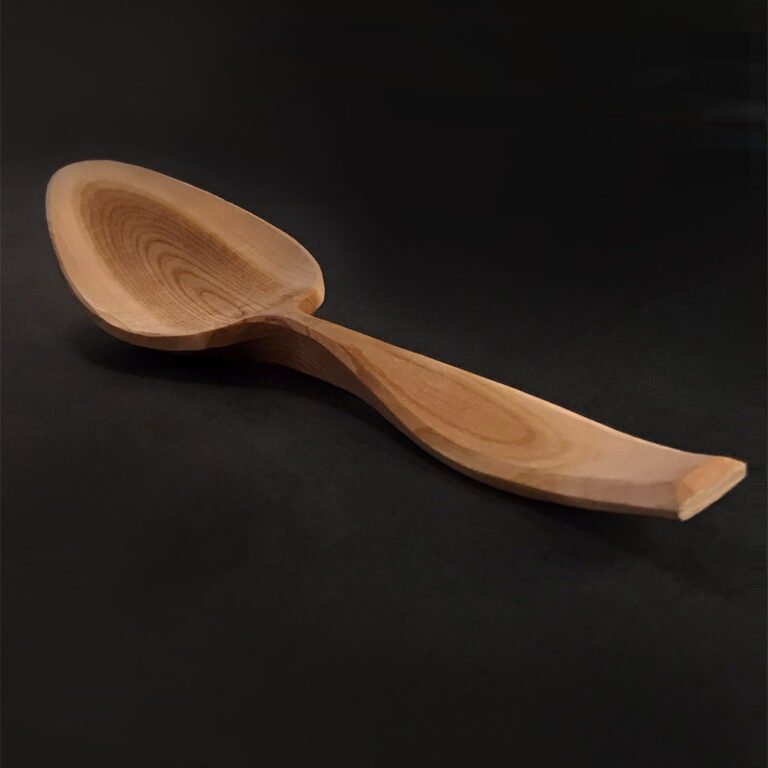 Front side of a wooden eating spoon from cherry wood by Dio