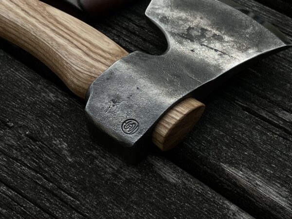 The Sloyd carving axe hand-forged for spoon carving and green woodworking on a table